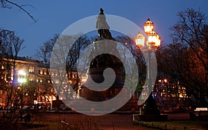 Monument to Catherine II, silhouette viewed at night, illuminated Nevsky Prospekt in the background, St. Petersburg, Russia