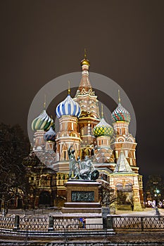 Monument to citizen Minin and Prince Pozharsky against the background of St. Basilâ€™s Cathedral in the evening in January.