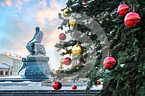 Monument to Dostoevsky at the Lenin Library in Moscow and Christmas balls on the tree