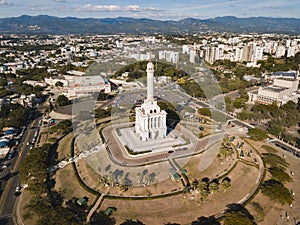 Monument to the Heroes of the Restoration surrounded by buildings in the Dominican Republic photo