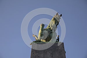 Monument to the horseman against the background of the blue sky.