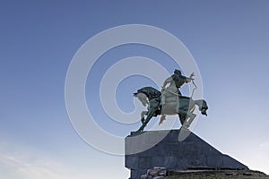 Monument to the horseman against the background of the blue sky.