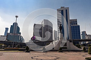 Monument to King Rama VI and the skyscrapers of Silom in the background