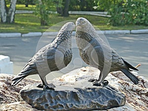 Monument to lovers student couples. The sculpture consists of two huge cooing pigeons and a bronze plate `hands of love`.