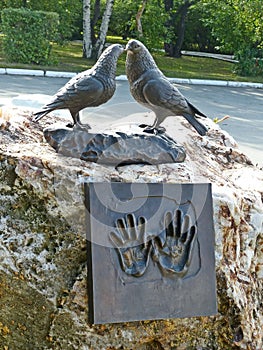 Monument to lovers student couples. The sculpture consists of two huge cooing pigeons and a bronze plate `hands of love`.