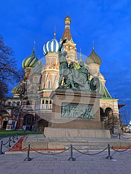 Monument to Minin and Pozharsky on the background of St. Basil`s Cathedral in the autumn evening