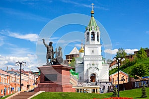 Monument to Minin and Pozharsky with Orthodox church in Nizhny Novgorod, Russia. Summer sunny day
