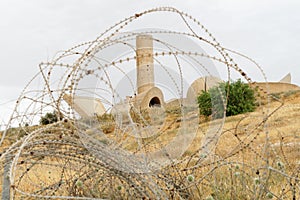 Monument to the Negev Brigade in Beer Sheva, Israel, seen through the barbed wire