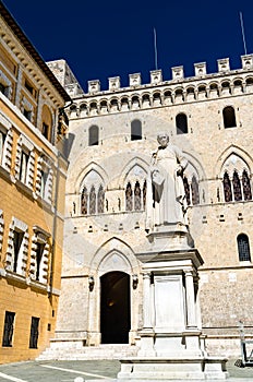 Monument to Sallustio Bandini and Palazzo Salimbeni in Siena, Italy