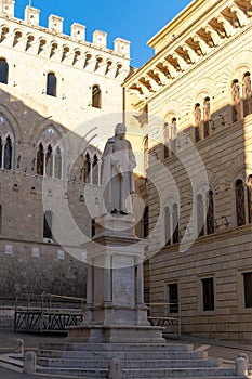 Monument to Sallustio Bandini and Palazzo Spannocchi, Gothic style urban palace in Piazza Salimbeni, Sienna, Tuscany region