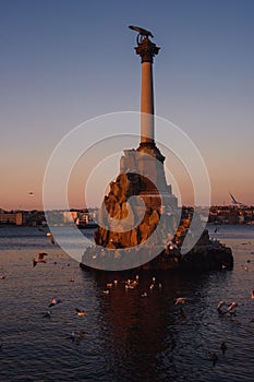 Monument to sunken ships in Black sea water on sunset. Sevastopol, Crimea