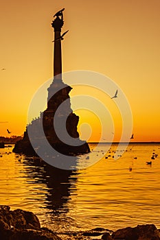 Monument to sunken ships in Black sea water on sunset. Sevastopol, Crimea