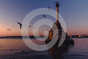 Monument to sunken ships in Black sea water on sunset. Sevastopol, Crimea