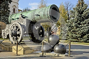 Monument to the Tsarâ€™s cannon in the Kremlin in Moscow. Russia. Clear sunny autumn day, green Christmas trees and yellow trees