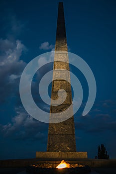 Monument to the Unknown Soldier with eternal fire in the evening. War memorial located in the Ukrainian capital of Kyiv. Park of