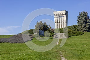 Monument to the Victims of Fascism in Krakow, on a clear, autumn day, lush grass, blue sky