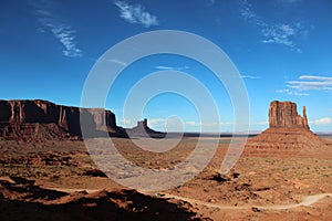 Monument valley landscape with blue sky and some cloud trails photo