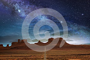 The monument valley under a night starry sky