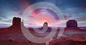 Monument Valley under a scenic sunset sky