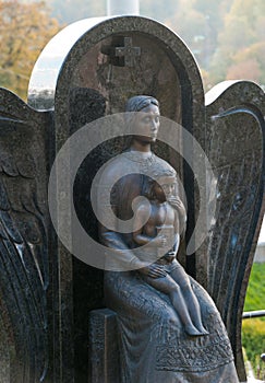 Monument of the woman with the child on a cemetery