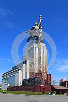 Monument worker and collective farm girl on a background of blue