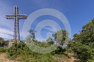 The monumental cross overlooking the summit of Monte Argentario, Tuscany, Italy, on a sunny day