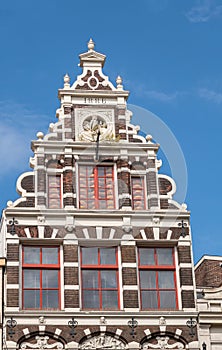 Monumental gable with cheeses behind window, Amsterdam, Netherlands