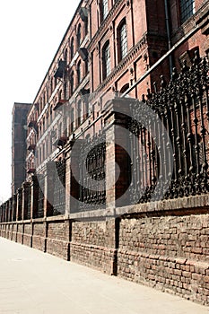 Monumental, old factory behind the wall