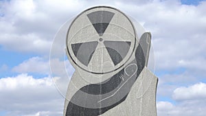 Monumentum of radioactive hazard on blue sky background. Chernobyl tragedy concept.