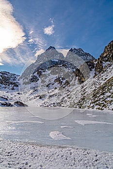 Lake Fiorenza covered with ice on the slopes of Monviso photo