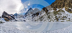 Lake Fiorenza covered with ice on the slopes of Monviso photo