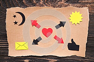 Mood board with heart, arrows, email icon, thumbs up icon and sun on old craft paper