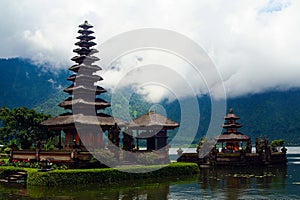 Moody atmosphere with low hanging clouds fog over lake photo