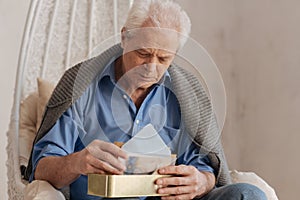 Moody cheerless man putting his letters in a box