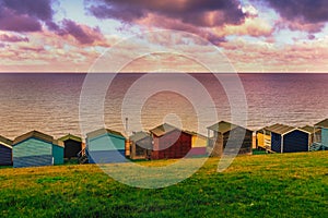 Moody cloudy weather creating patches of sunlight between the clouds on the sea in Tankerton, Whitstable in Kent.