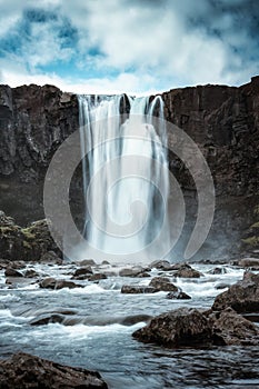 Moody Gufufoss waterfall flowing on summer in east fjords