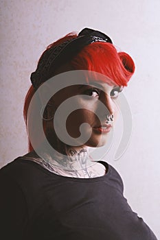 Moody portrait of girl with piercings and tattoos