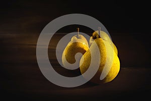 Moody shot of organic yellow pears.