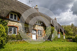 Moody skies above a thatched cottage in Dorset, England.