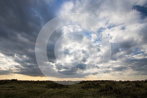 Moody sky cloudscape, Mottled blanket of cloud over barren coast