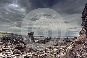 Moody sky over dramatic, rocky coastline of South Wales, UK