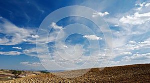 Moody sky on plowed land