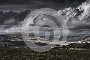 Moody sky with rainclouds over scenic mountain valley in Lake District, UK