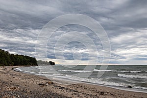 Moody stormy gray clouds over the sandy beachfront shore of Lake Erie at Wendt Beach Park, New York, USA