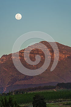 Moon above a mountain at sunset