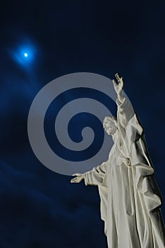 Moon beyond Jesus Christ statue