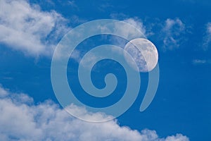 Moon on the blue sky with white cloud.