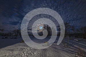 Moon and Cirrus clouds over village