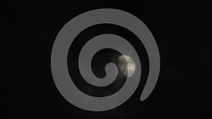 Moon with clouds in the night sky. Cloudy weather on a autumn night. Mysterious night sky with moon. Spooky night and mystery. Dr