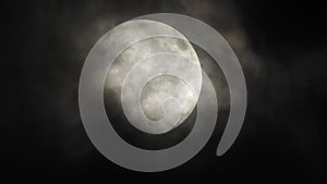 Moon with clouds in the night sky. Cloudy weather on a autumn night. Mysterious night sky with moon. Spooky night and mystery. Dr